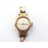 Accurist, a 9 carat gold lady's watch, the silvered dial with baton markers and hands, with 21 jewel