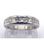 A platinum and diamond half hoop ring, channel set with twelve princess cut diamonds, the shank