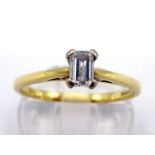 An 18 carat gold and single stone diamond ring, the central baguette cut approx. 0.30 carat, the