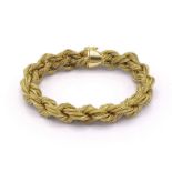 A gold braided bracelet, composed of 15 interwoven strands, (tests 18 carat gold), 20cm long, 69.