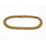 A braided gold collar, composed of six interwoven strands, to a box snap clasp stamped '750', 37cm