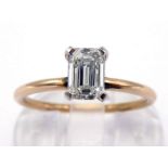 A single stone diamond ring, the baguette cut approx. 0.55 carat, claw set above a rose gold