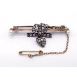 A late 19th century diamond and seed pearl brooch, the pink gold blade bar set to the centre with