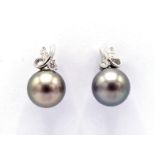 A pair of Tahitian black cultured pearl and diamond earrings, each with a 10.9mm pearl, with two