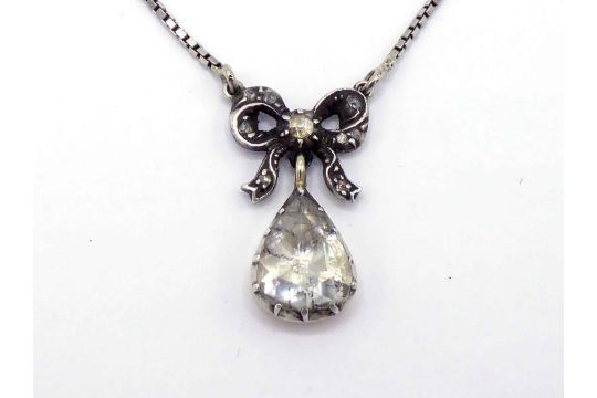 A rose cut diamond pendant, the pear shaped stone 11 x 9mm, mounted in gold backed silver, to a - Image 1 of 3