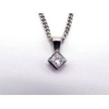 An 18 carat white gold and single stone diamond pendant, the small 2.8mm princess cut rub over