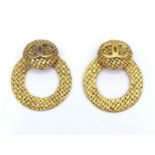 CHANEL, a pair of late 70s/early 80s gilt metal ear clips, numbered and signed, of weave design,