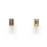 A pair of single stone diamond ear studs, each emerald cut stone approx. 0.30 carat, mounted in