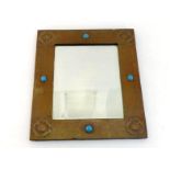 A large Arts and Crafts copper-framed mirror with bevelled glass, circa 1910, riveted copper