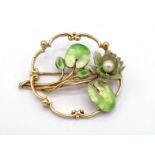 A 14 carat gold, enamel and cultured pearl brooch, the enamel and pearl waterlily design within a