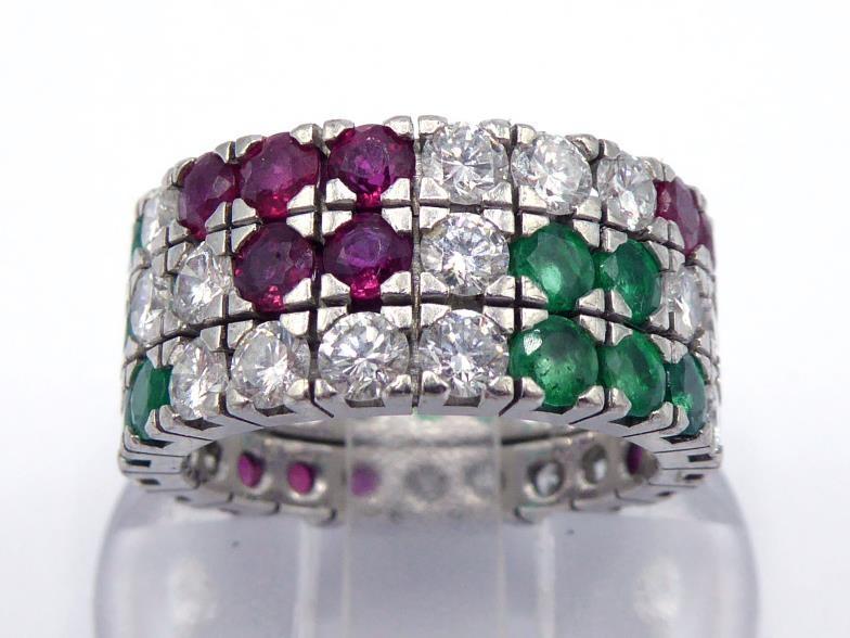 A ruby, emerald and diamond ring, a three row grid pattern of pave set round cut emeralds, rubies