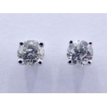 A pair of single stone diamond ear studs, each brilliant approx. 0.14 carat, mounted in 18 carat