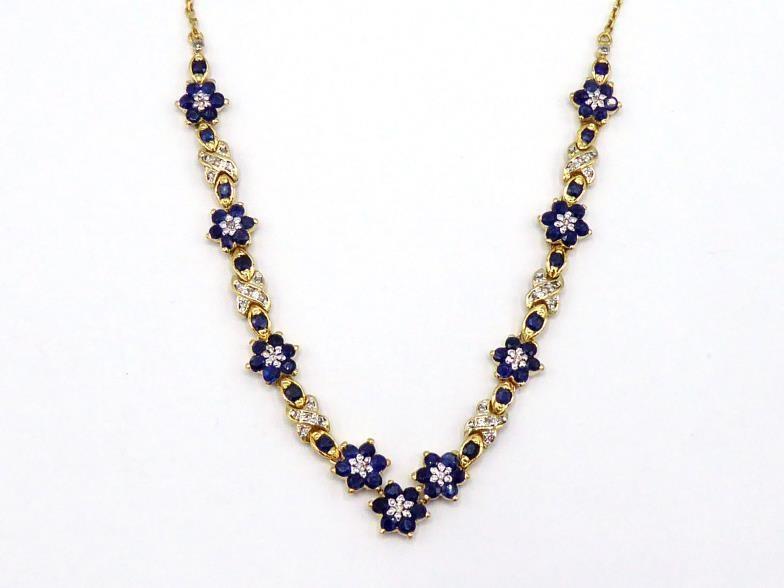 A sapphire and diamond necklace, composed of alternate daisy clusters of sapphires and pave set