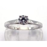 A French 18 carat white gold and diamond single stone ring, the central brilliant approx. 0.30