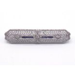 A sapphire and diamond bar brooch, in the Art Deco style, the filigree panel set with three