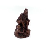 A Chinese carved wood figure, depicting a scene of an old man and a child catching fish from the