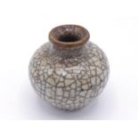 A Chinese “Ge” ware water pot in globular form standing on circular foot and flared lip, body with