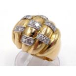 A French 18 carat gold and diamond bombe dress ring, the high domed and fluted bezel with pairs of