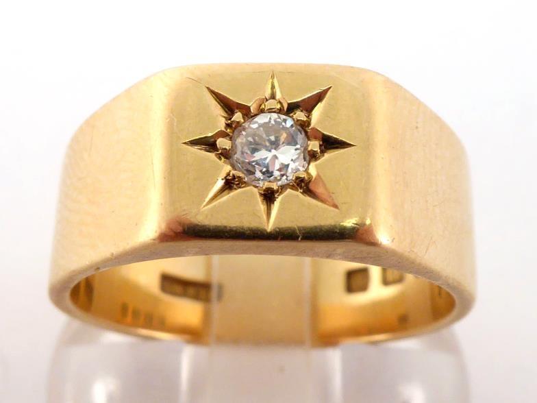 An 18 carat gold and diamond gentleman's ring, gypsy set to the centre with a small approx. 0.10