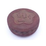 An Oriental cinnabar lacquer box of circular form, the cover and base finely carved throughout,