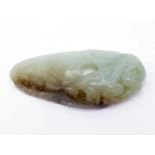 A Chinese carved celadon jade pendant in the form of a chicken heart, the front carved in relief