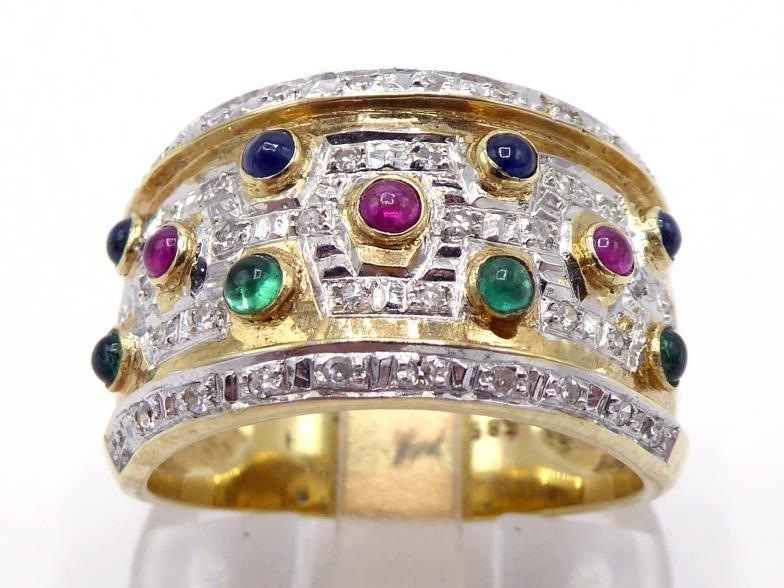 A multi gem set dress ring, the wide band set with rows of small cabochon cut rubies, sapphires, and