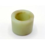 A Chinese carved celadon jade archer ring, of plain form, stone in pale celadon tone, 19th/20th