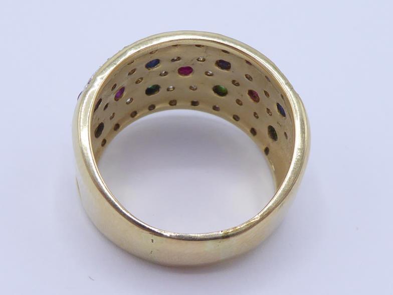 A multi gem set dress ring, the wide band set with rows of small cabochon cut rubies, sapphires, and - Image 2 of 3