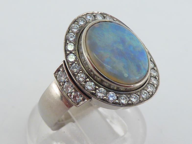 A precious opal and diamond cluster ring, the central oval opal cabochon 12 x 9.5mm, in a surround - Image 2 of 4