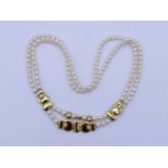 An Italian 18 carat gold, diamond and cultured pearl necklace by MANFREDI, the two strand necklace