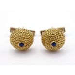 A pair of 18 carat gold and sapphire cufflinks by Kutchinsky, the domed honeycomb textured links