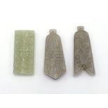 A group of three Chinese carved jade pendants, two white jade carved in bell shape, with scrolling
