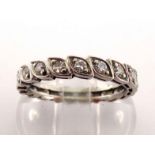 A diamond eternity ring, set overall with small single-cuts in segmented mount, mounted in white