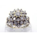 An 18 carat gold and diamond cluster ring, the tiered cluster centring on a 0.16 carat brilliant,