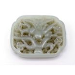 A Chinese carved white jade dragon plaque of rectangular form with incurved corners, back ground