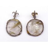 A pair of rutilated quartz and diamond earrings, each off-round quartz disc in a surround of small