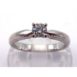 A diamond single stone ring, the brilliant cut approx. 0.23 carat, above a white shank, stamped '