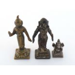 Three Indian Deities, a silver Ganesh, ht. 3.5cm., wt. 48gm., and two 19th century brass figures,