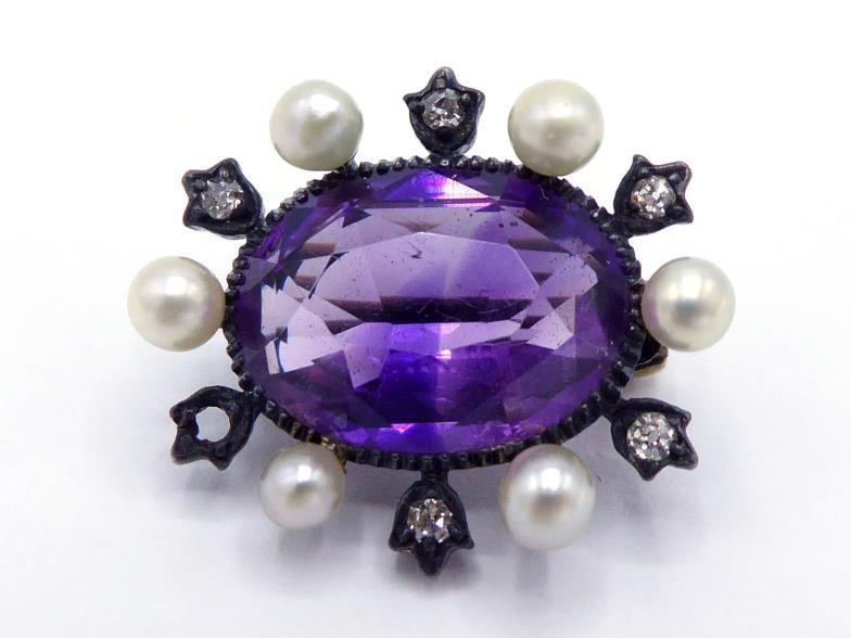 A Victorian amethyst, diamond and seed pearl brooch, the central oval cut amethyst 12 x 8mm, in a