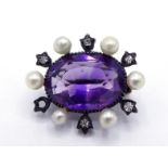 A Victorian amethyst, diamond and seed pearl brooch, the central oval cut amethyst 12 x 8mm, in a