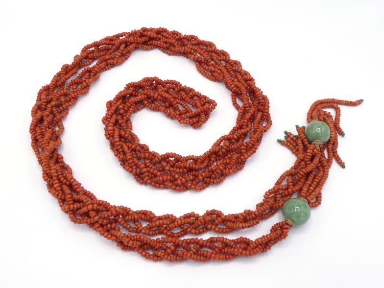 A 20th century Chinese coral and jadeite robe cord, composed of four strands of braided coral, to