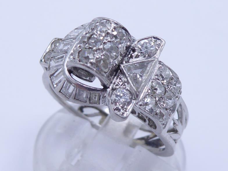 A mid 20th century diamond dress ring, the ornate buckle design set overall with single cuts and - Image 3 of 4