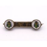 An Italian 19th century silver gilt and micromosaic bar brooch, each circular terminal set with a