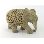 An Indian elephant very finely carved and decorated with flowers, birds and scrolling forms