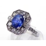 A sapphire and diamond cluster ring, the central oval cut sapphire approx. 2.15 carat, in a pave set