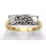 An 18 carat gold and three stone diamond ring, the three graduated brilliants totalling approx. 0.85