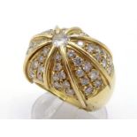 A diamond bombe dress ring, the large domed bezel centred on a 0.23 carat brilliant cut, to pave set