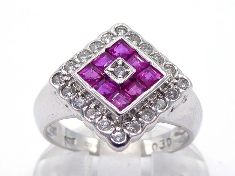 An 18 carat white gold, diamond and ruby plaque ring, the square plaque with a central calibre cut
