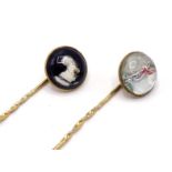 Two reverse crystal intaglio stickpins, the circular intaglios depicting the head of a wolfhound and
