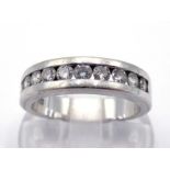 A diamond band ring, tension set with ten small brilliants totalling approx. 0.46 carats, the